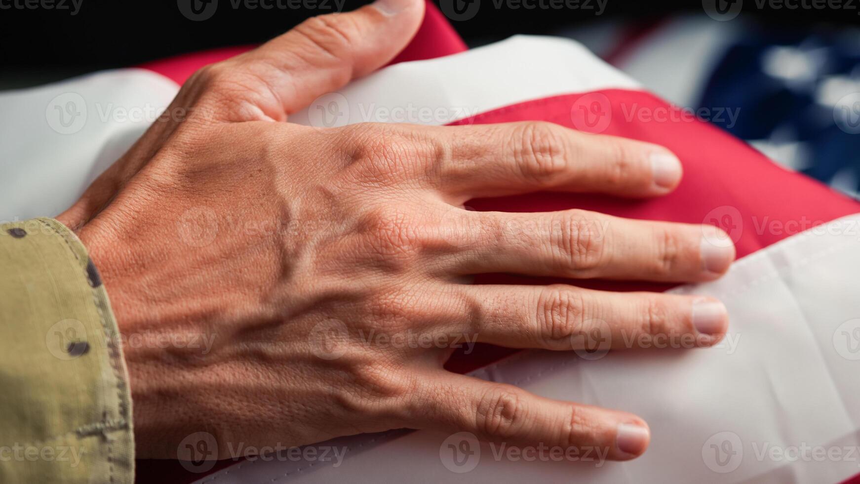 Hand of a solider touching USA flag photo