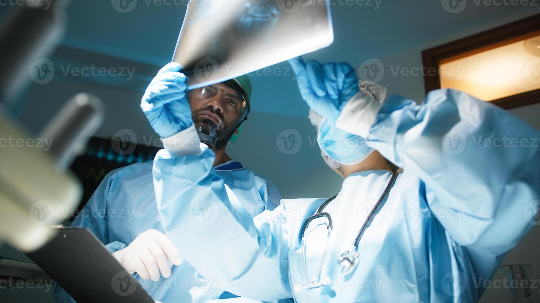 Doctors examine x-ray in surgery room photo