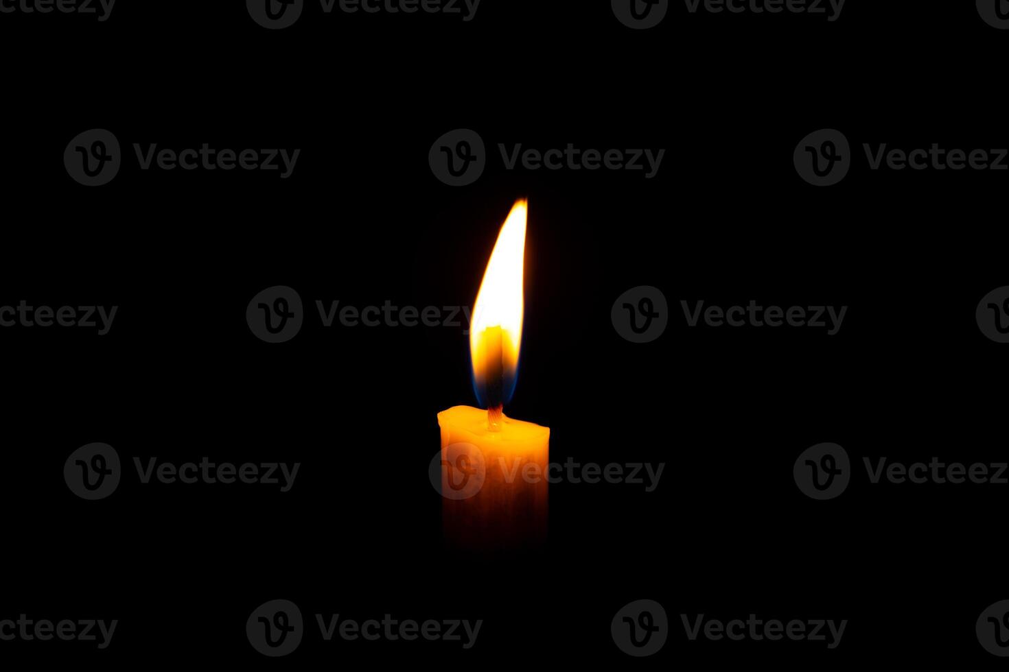 Burning White Candle on the dark, flame of candle on black background photo