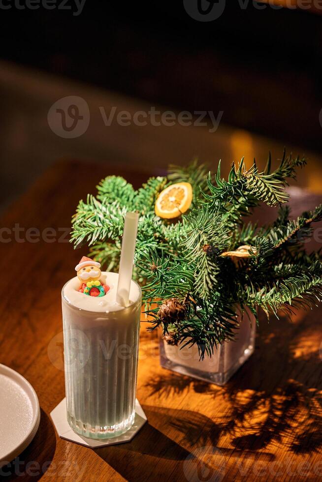 Smoothie in glass cups. Dark background with garland lights bokeh. Christmas and New Year sweet dfink and food holiday concept photo