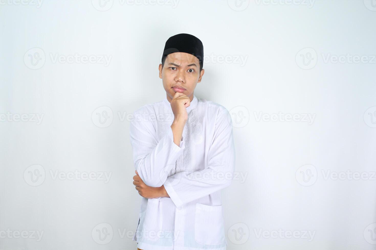 muslim man asian looking at camera with hand on chin to think about something isolated on white background photo