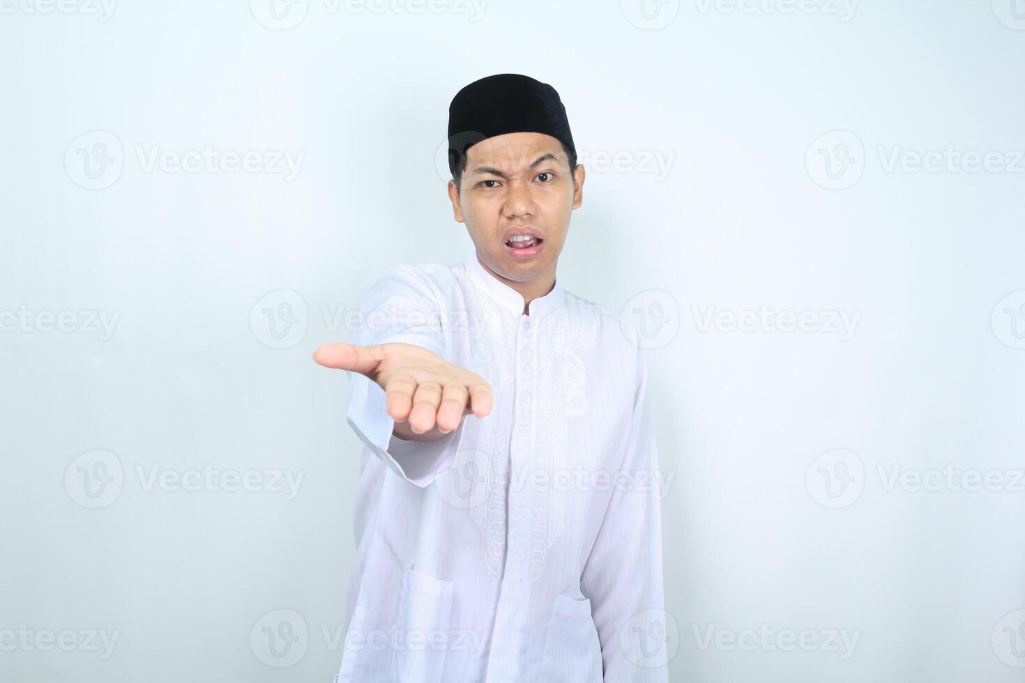 confused asian muslim man presenting empty palm at camera isolated on white backround photo