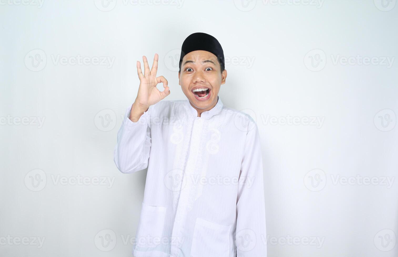 funny muslim man asian give okay signs with surprised expression isolated on white background photo