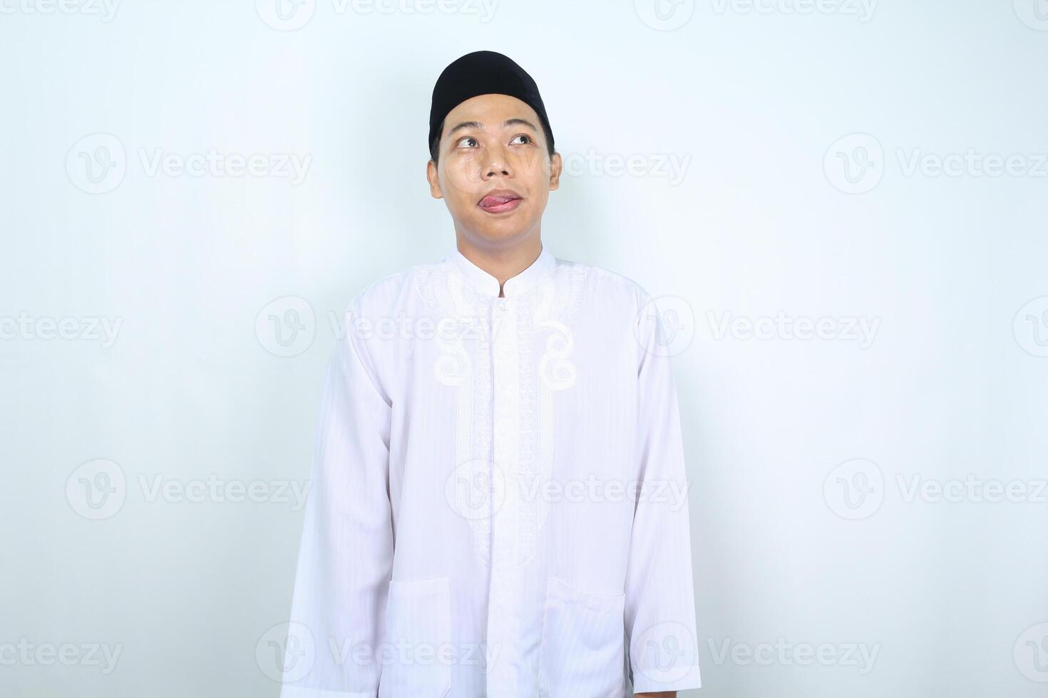 asian muslim man looking above imagine tasty food and beverage isolated on white background photo