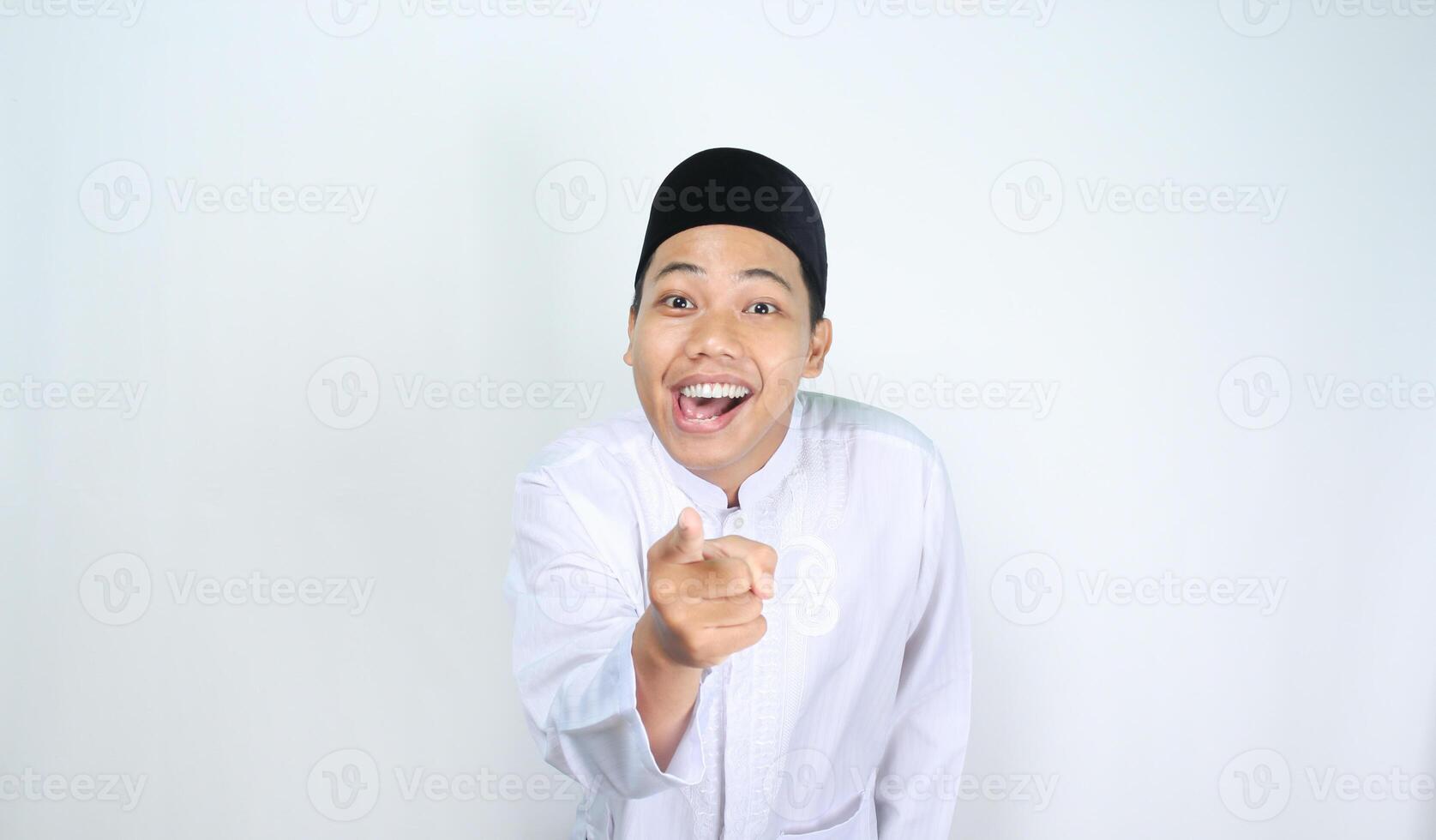 funny asian muslim man pointing hand forward with surprised expression isolated on white background photo