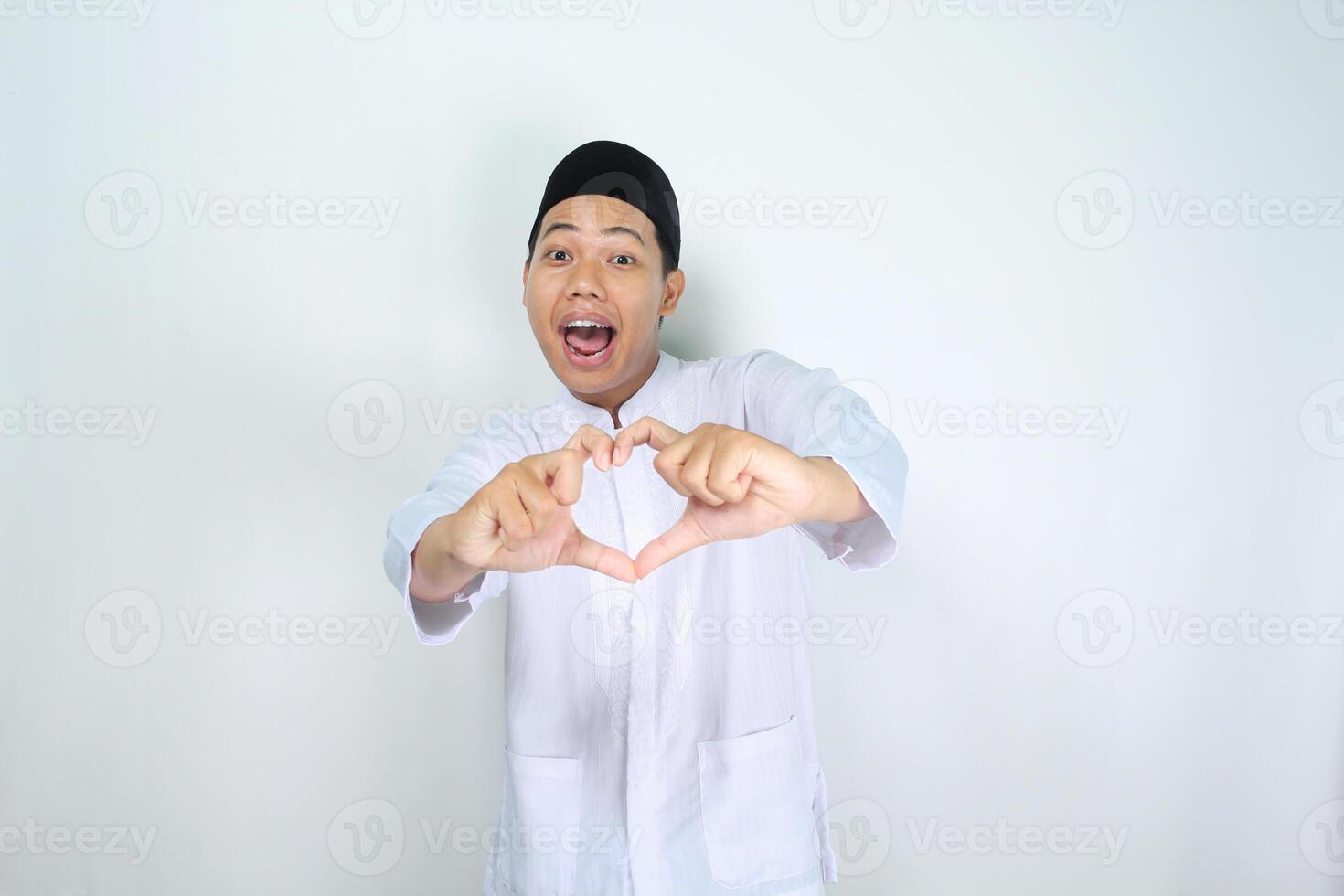 muslim asian man isolated on white background shouting while give heart shape photo