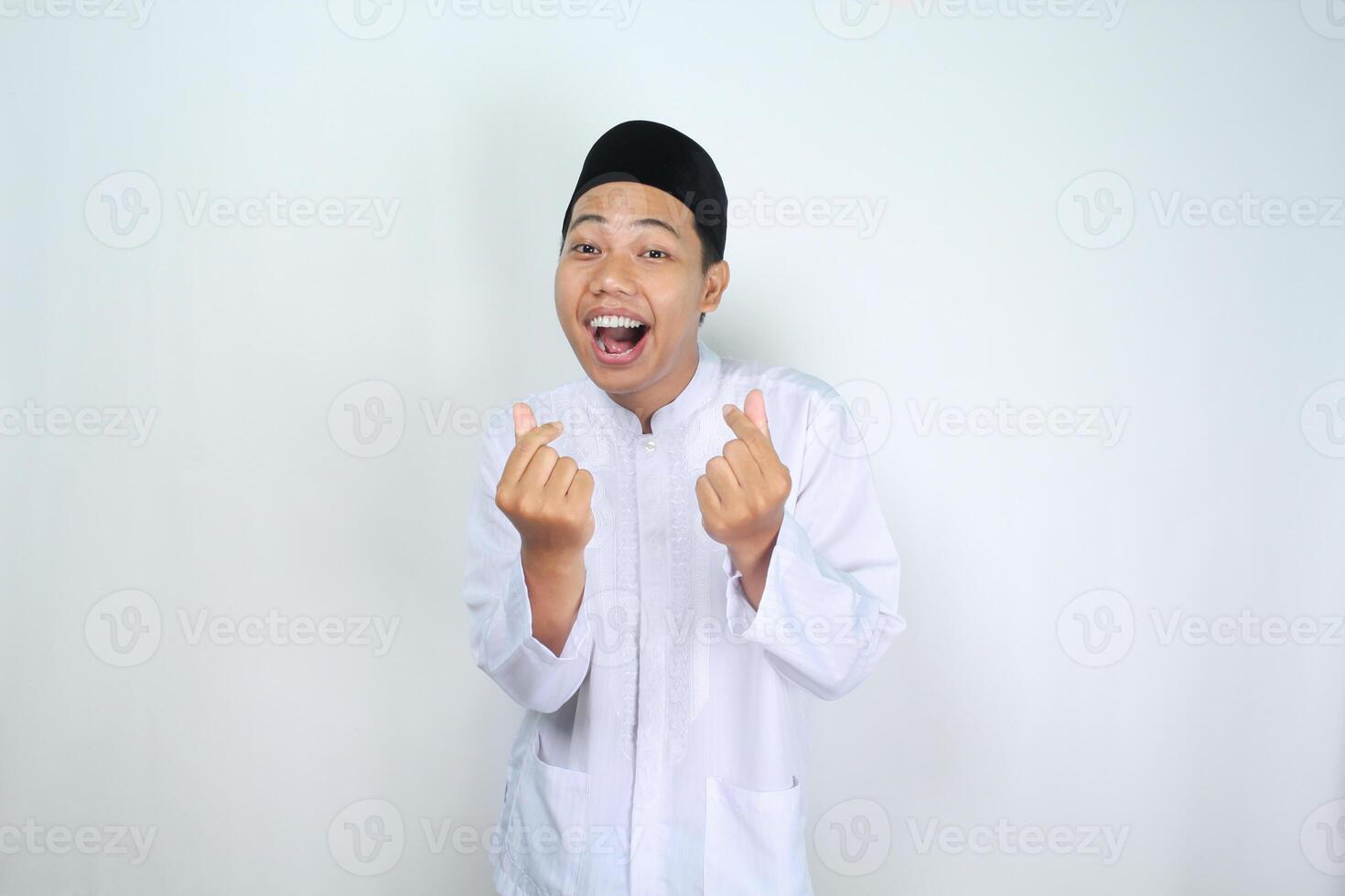 asian man muslim shouting while give korean love shape isolated on white background photo