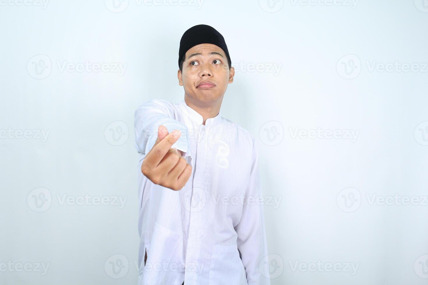 unhappy asian muslim man show korean love sign with confused face isolated on white background photo