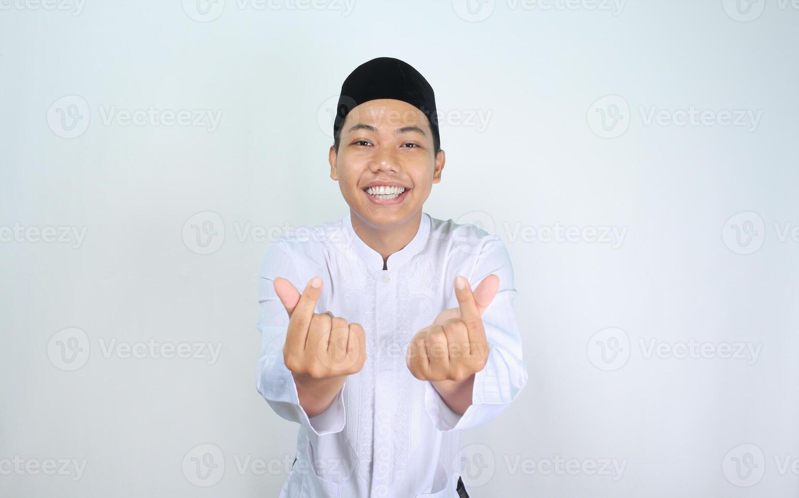 excited asian man muslim give korean heart shape at camera isolated on white background photo