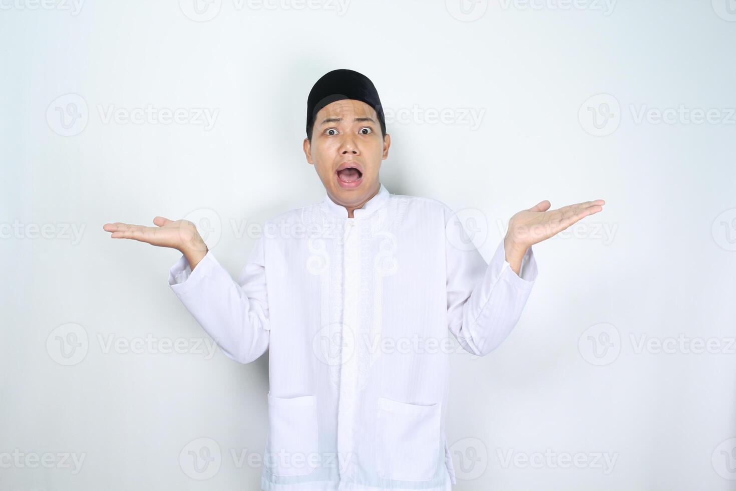 asian man muslim raising palm presenting to two side with shocked face expression isolated on white background photo