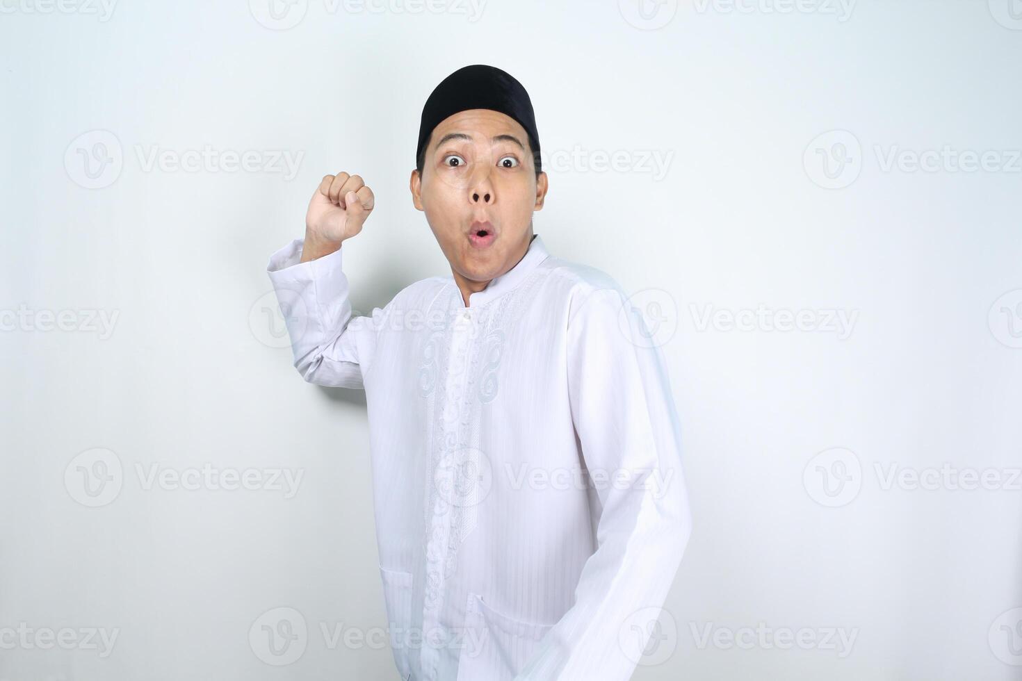 shocked asian man muslim posing to throw something isolated on white background photo