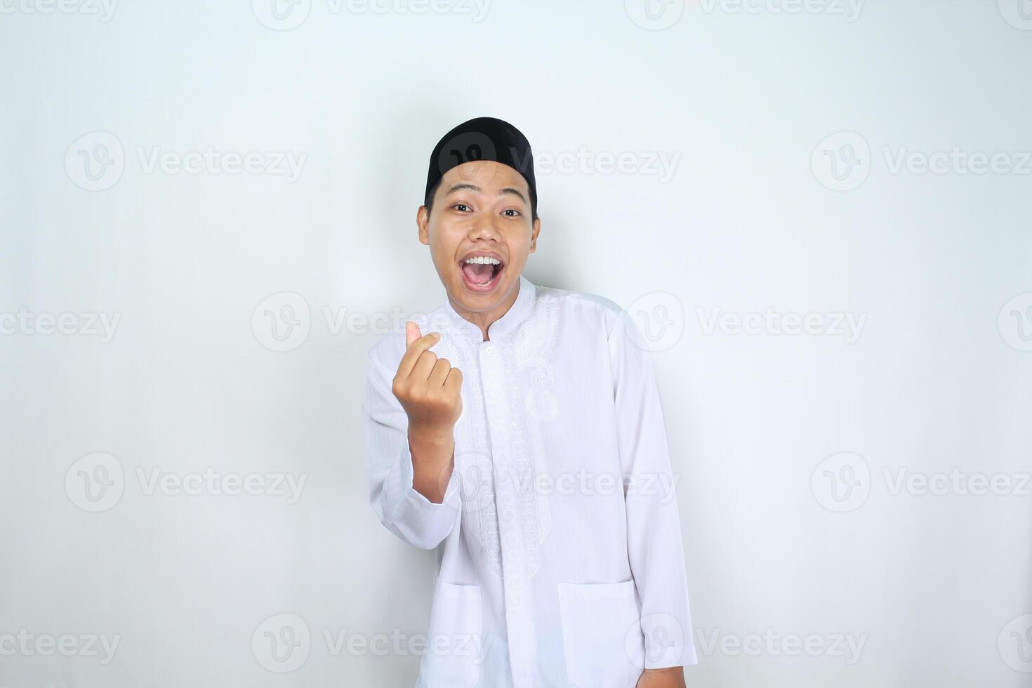 asian man muslim shouting while give korean love shape isolated on white background photo