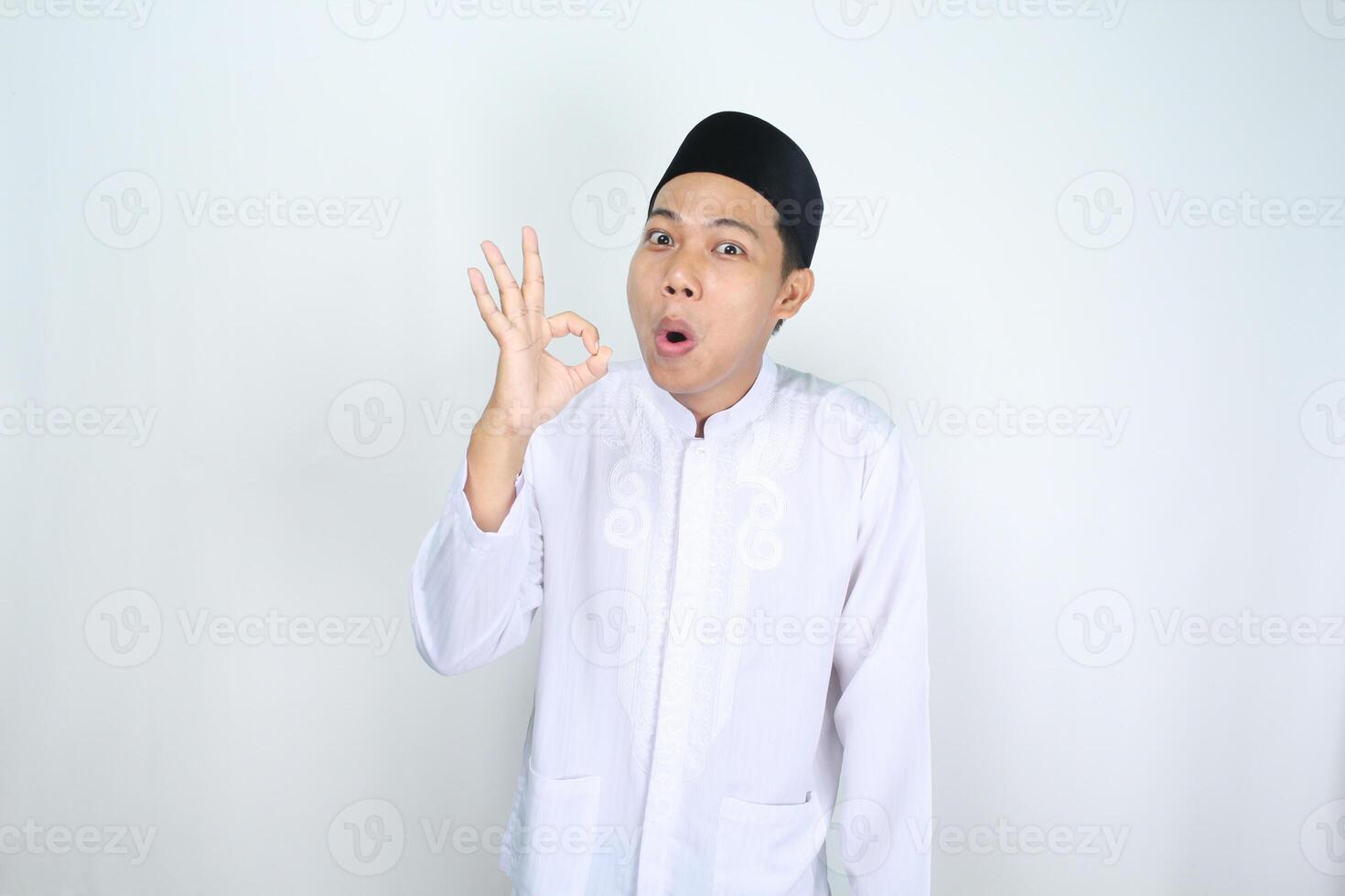 funny muslim man asian give okay signs with shocked expression isolated on white background photo