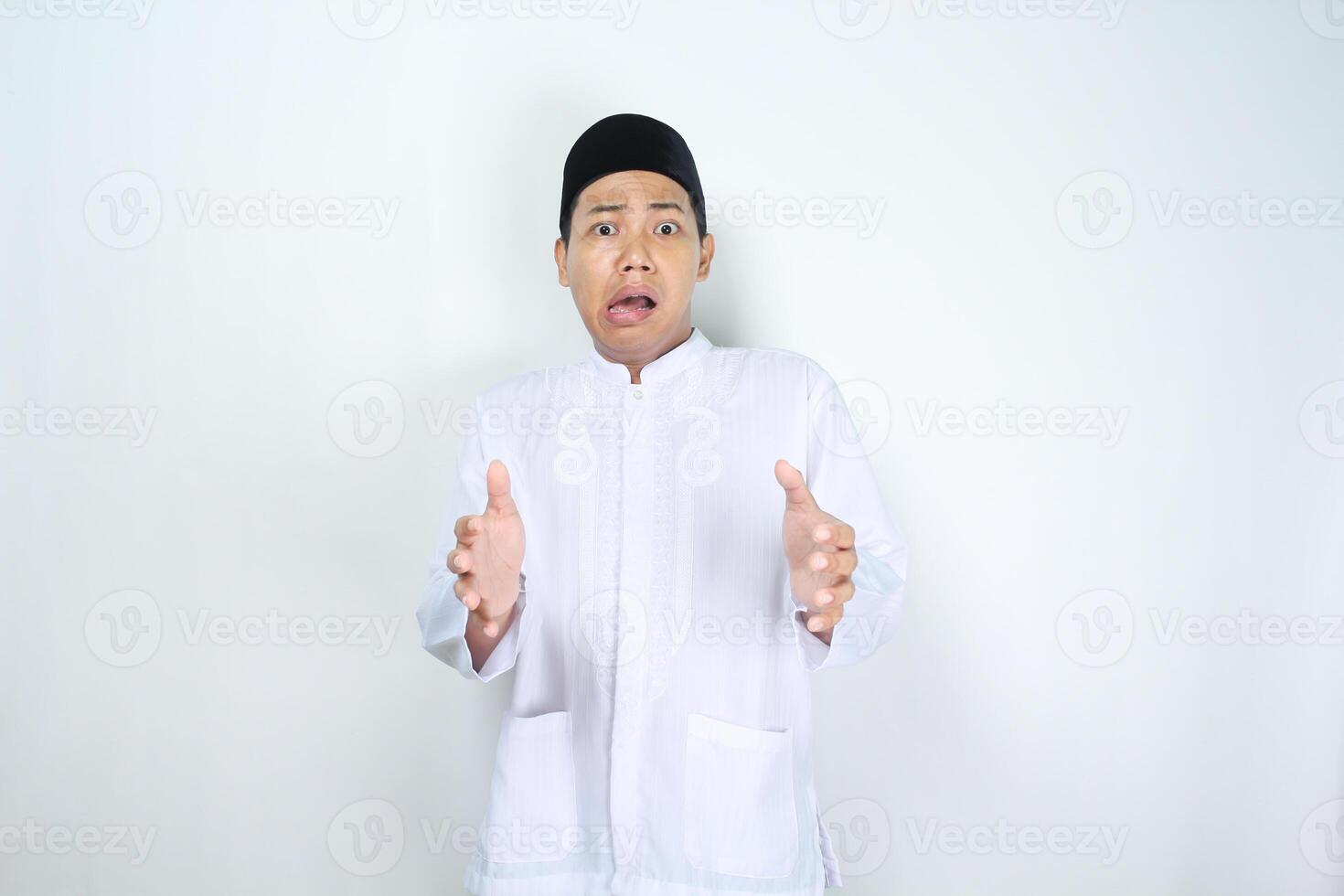 isolated muslim asian man looks shocked while posing holding box photo