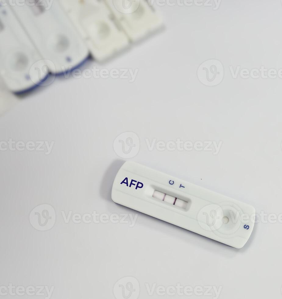 Rapid test kit for AFP or Alfa-fetoprotein testing, showing positive result, tumor or cancer marker for liver. photo