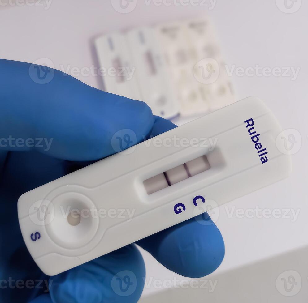 Rapid test device or cassette for Rubella or German measles test showing positive result at laboratory background. photo