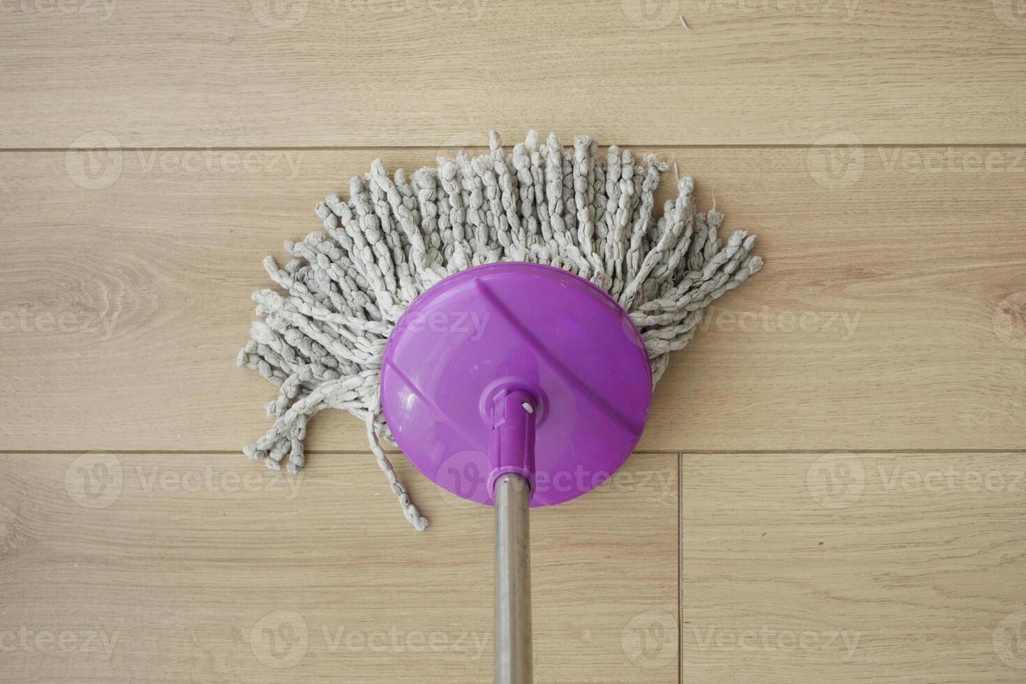 cleaning tiles floor with mop photo