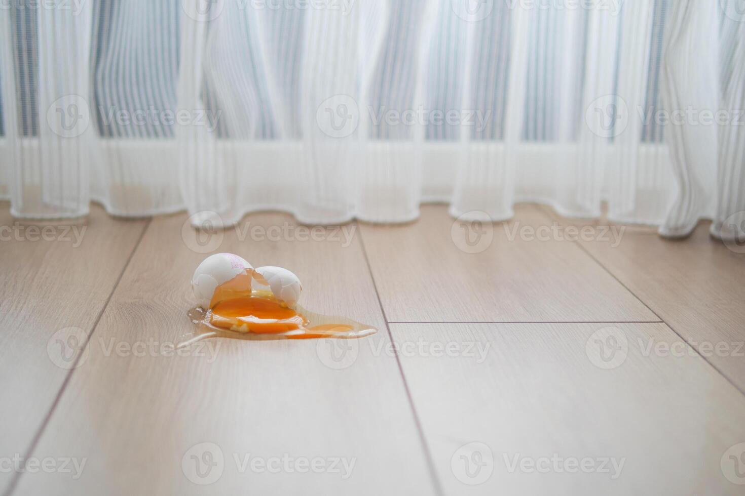 Fresh broken egg in kitchen floor photo