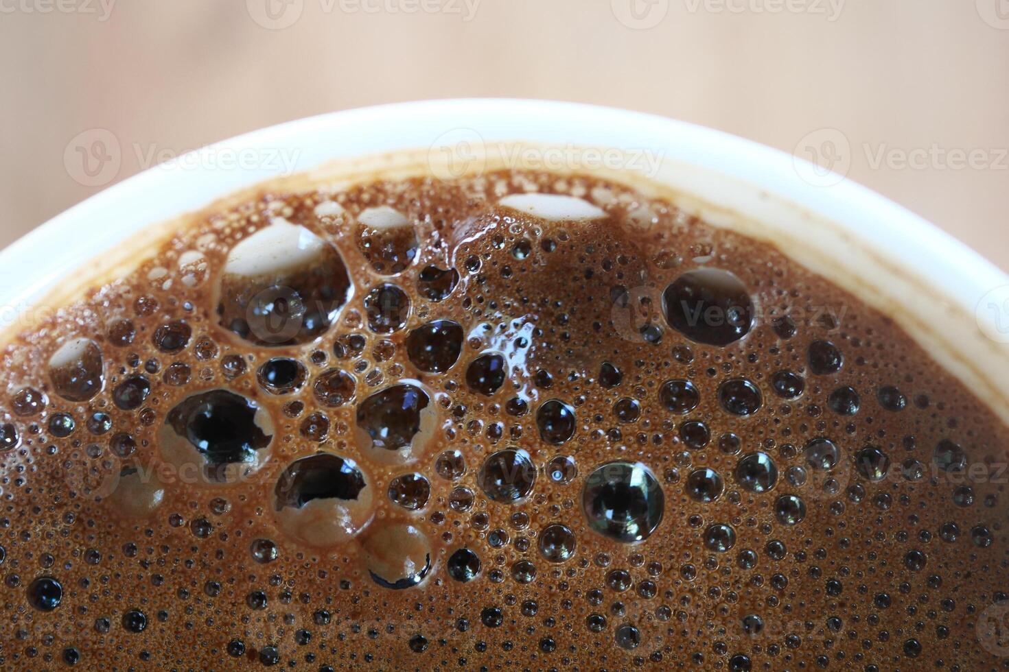 top view of hot coffee with bubble on white background photo