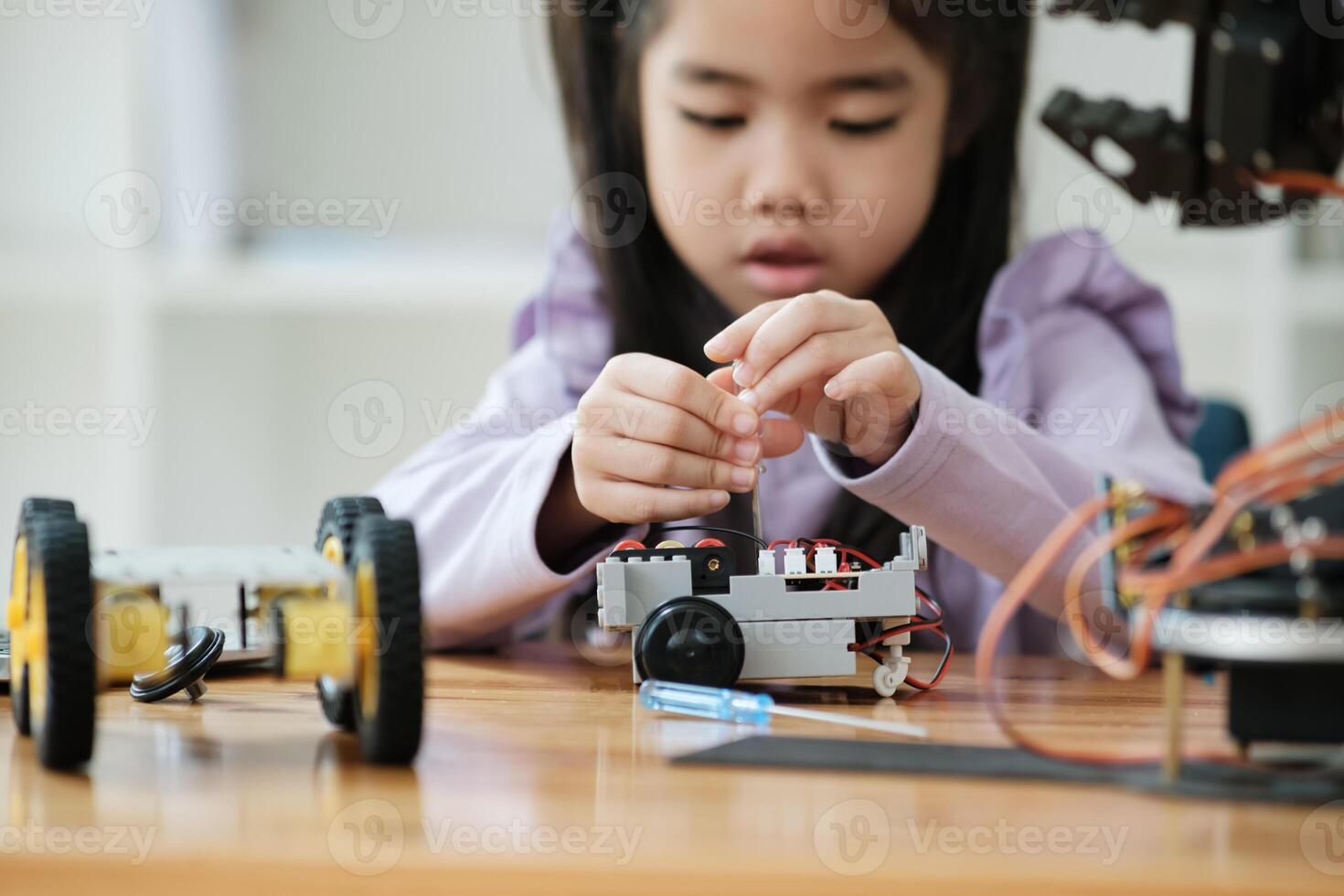 STEM education concept. Asian young girl learning robot design. photo