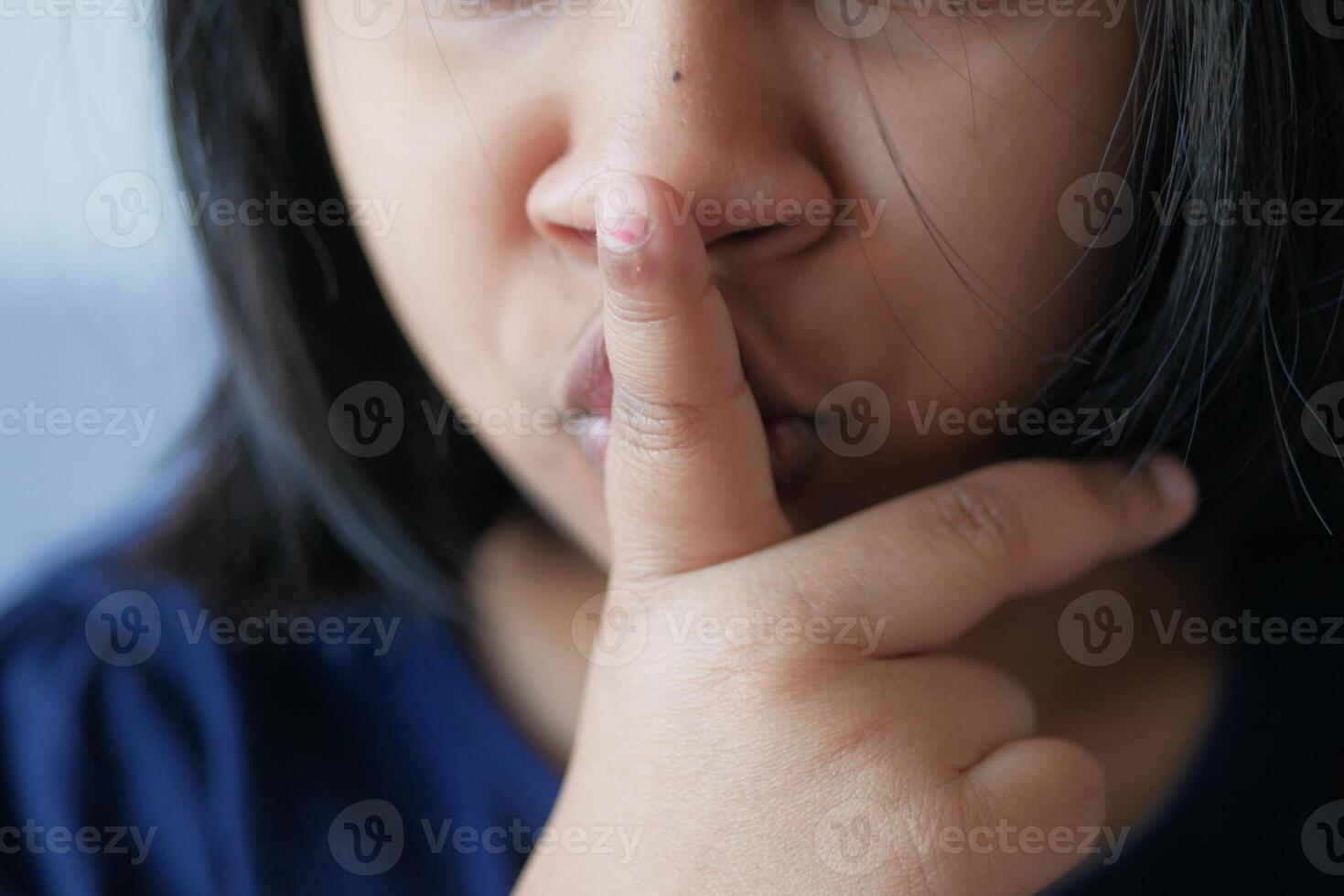 kid raising her hand indicating to stop talking or to be silent photo