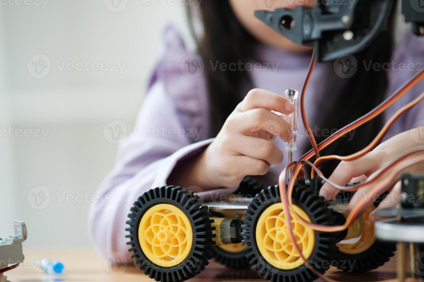 STEM education concept. Asian young girl learning robot design. photo