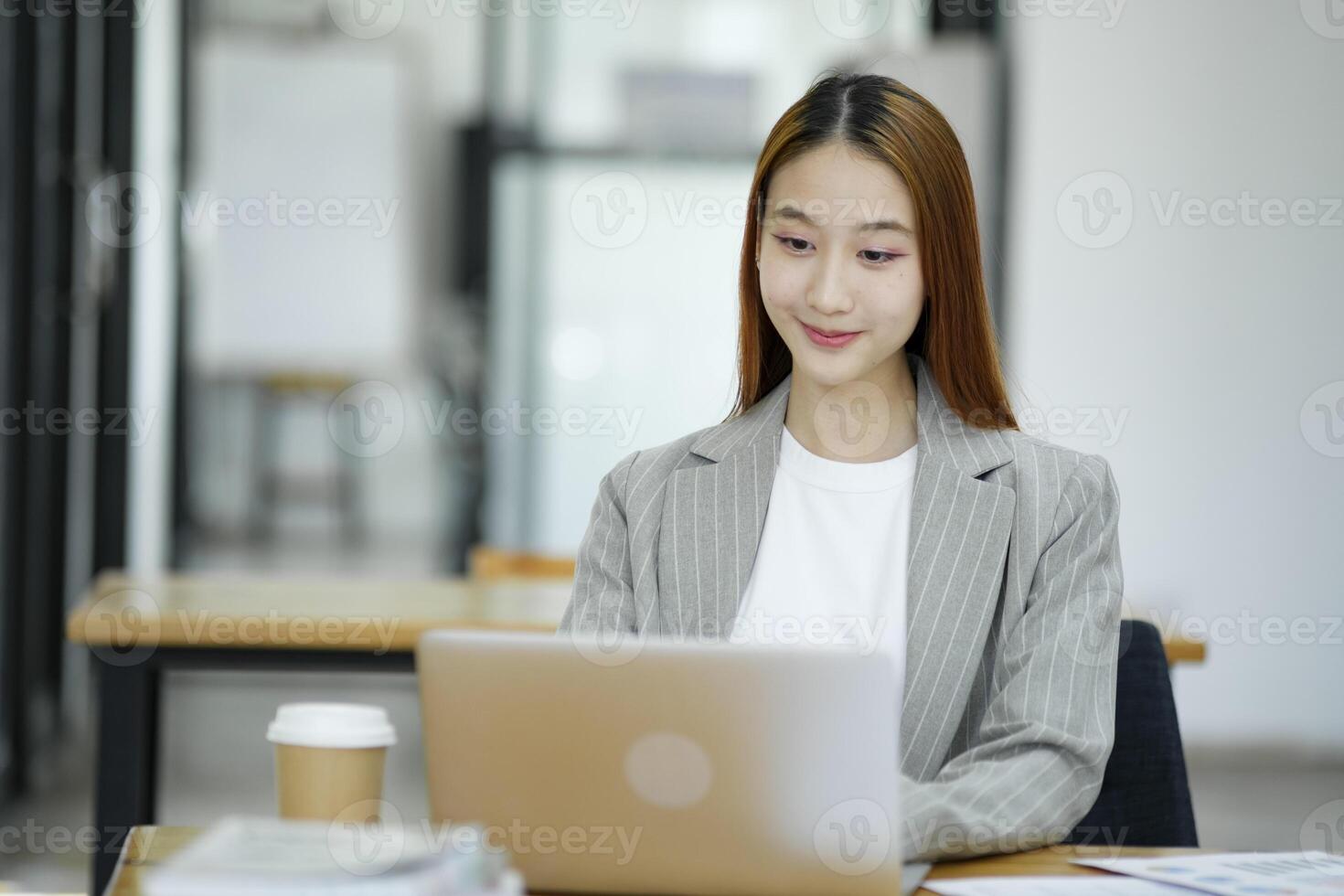 Business woman sitting working on her notebook with confidence and happiness doing a great job. photo