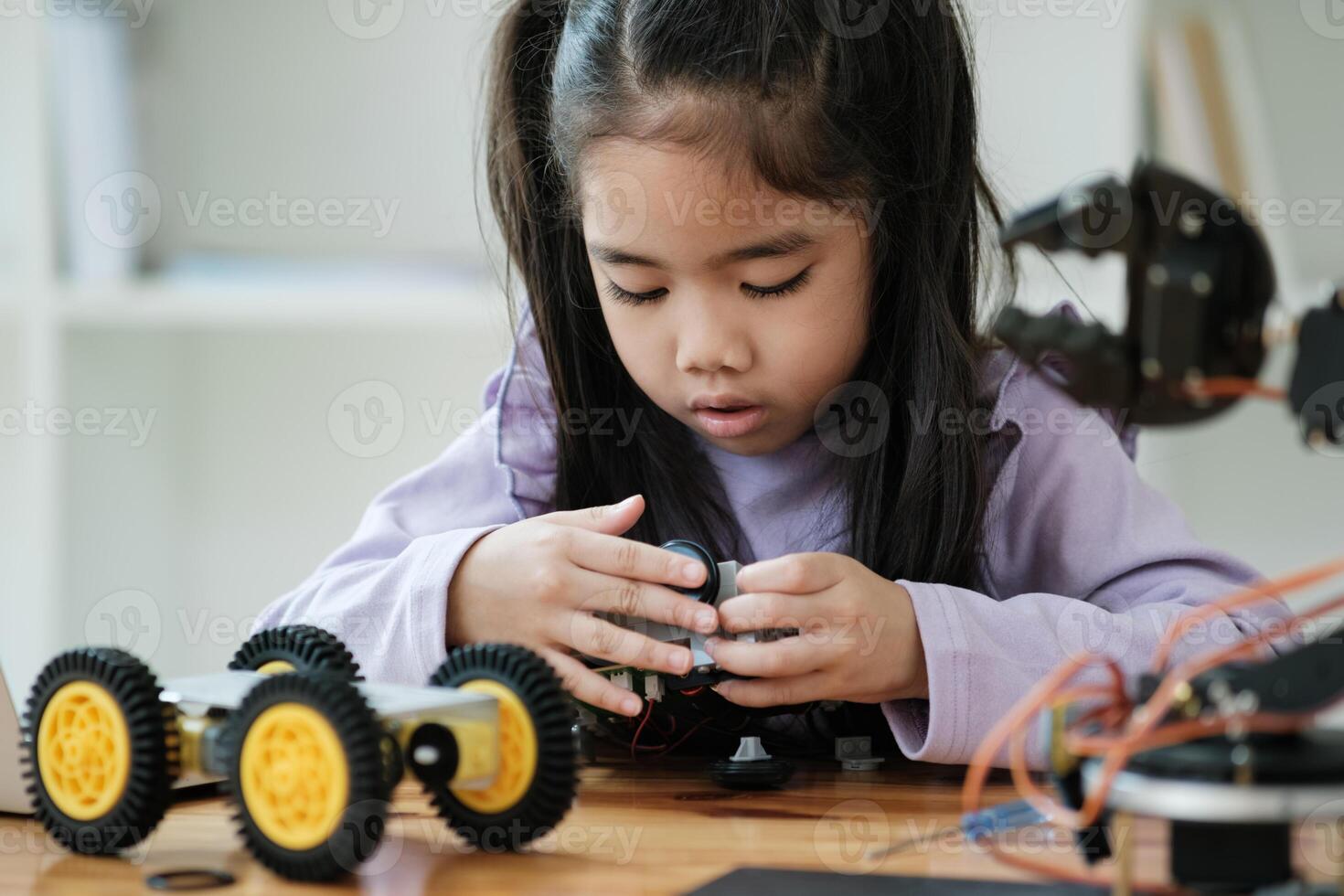 STEM education concept. Asian young girl learning robot design. photo