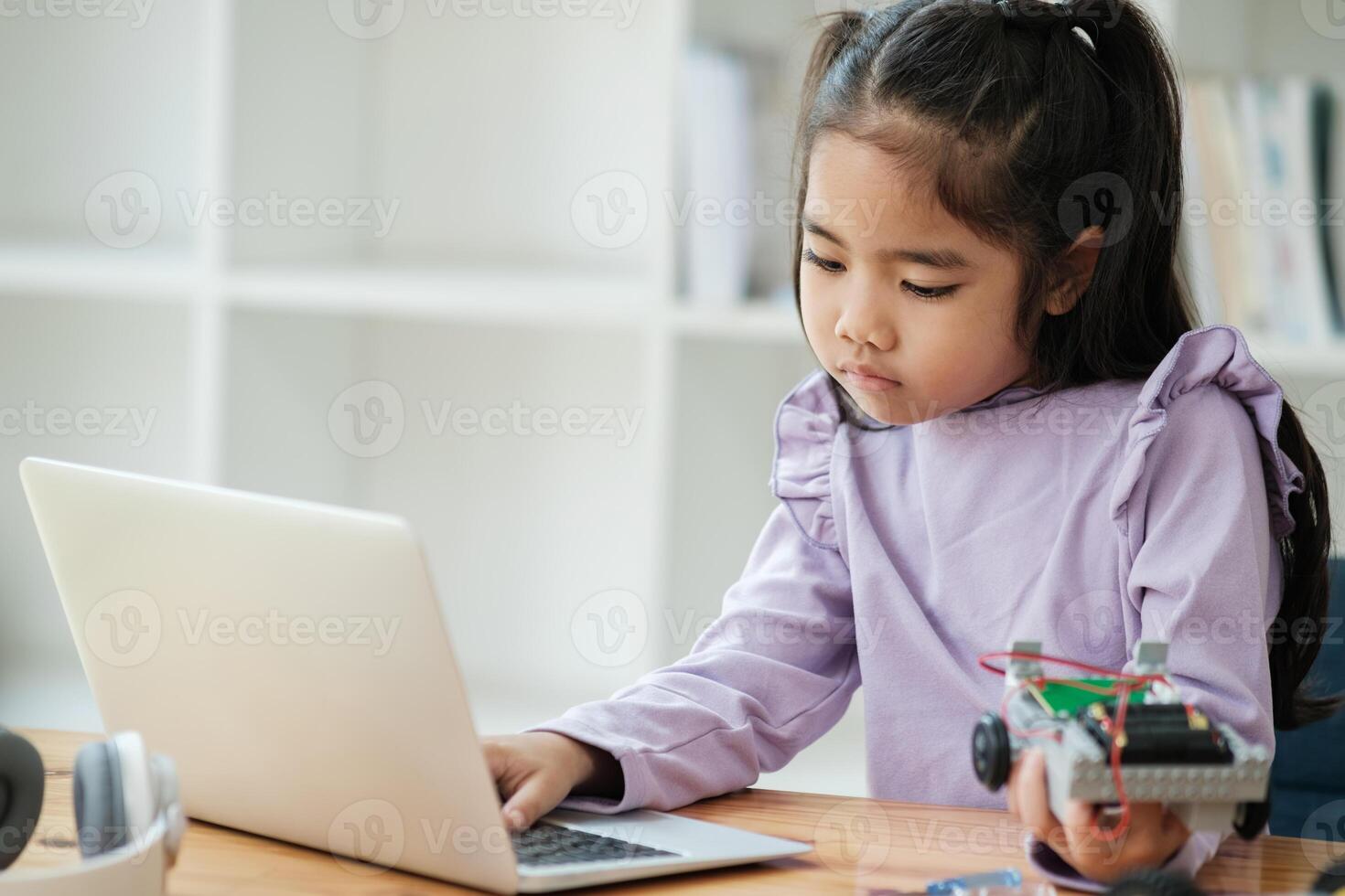 STEM education concept. Asian young girl learning robot design. photo