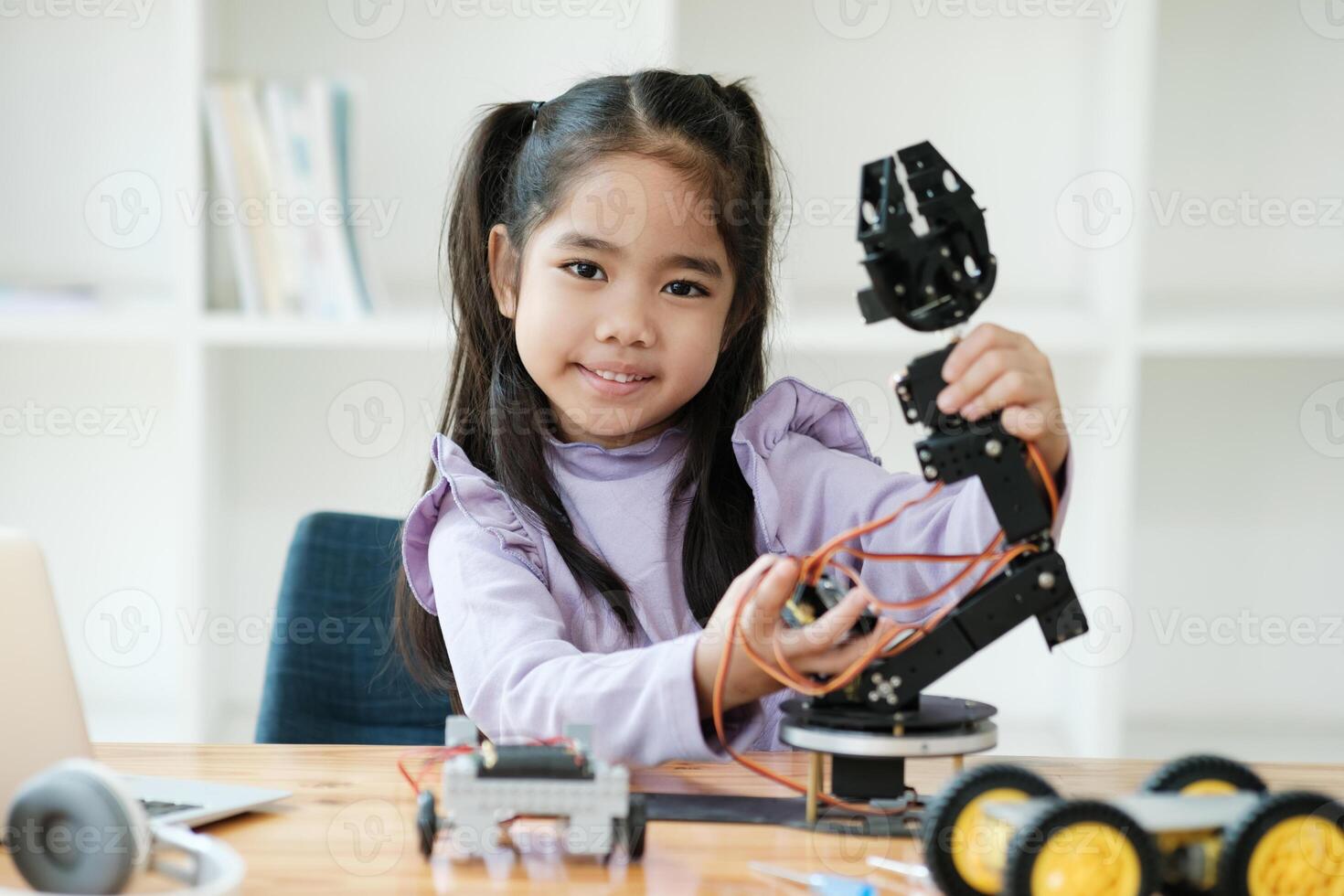 STEM education concept. Asian young girl learning robot design. photo