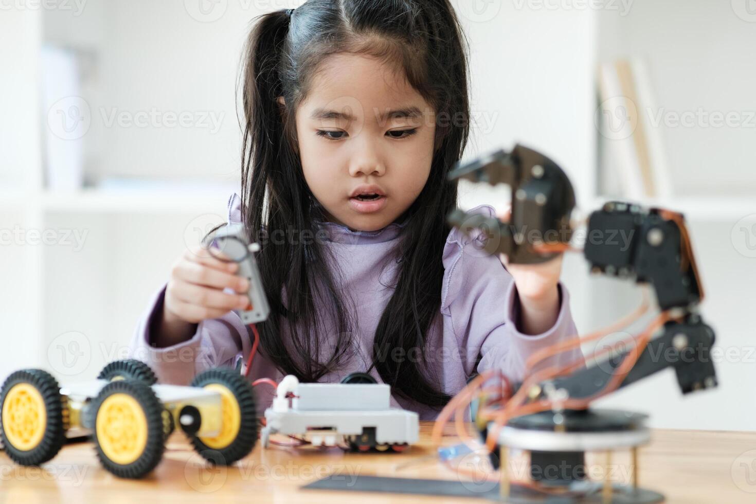 STEM education concept. Asian young girl learning robot design. photo