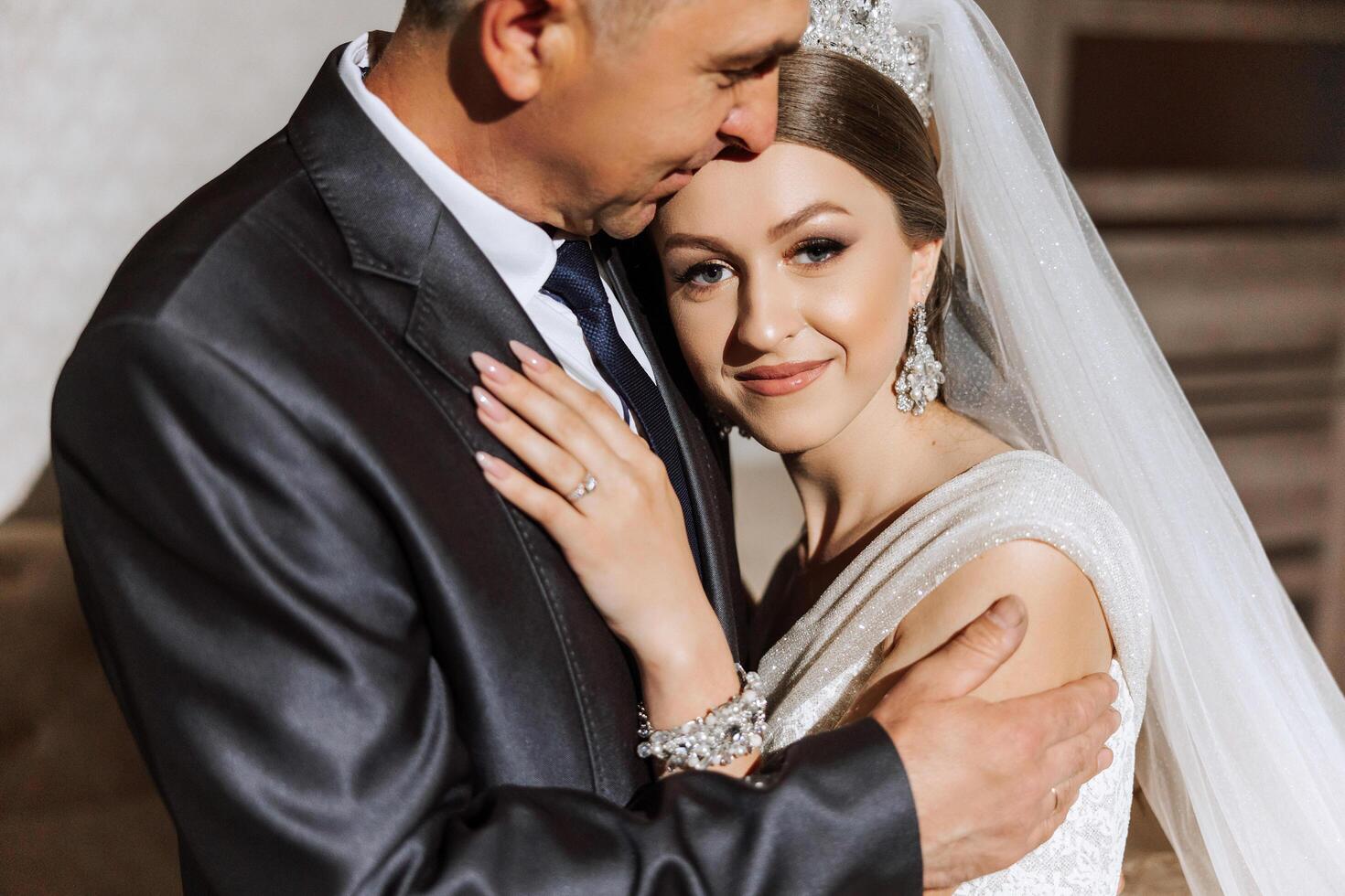 A beautiful bride with her father on her wedding day. The best moments of the wedding day. Daughter and father. photo