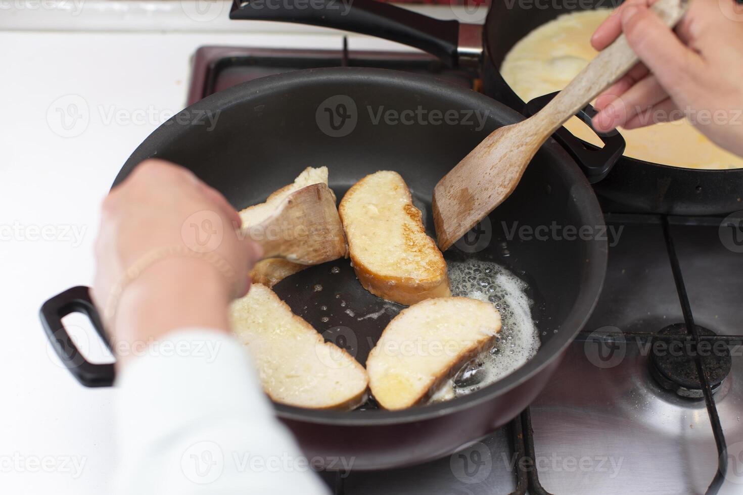 Fry white loaf croutons in a frying pan. Cook breakfast. photo