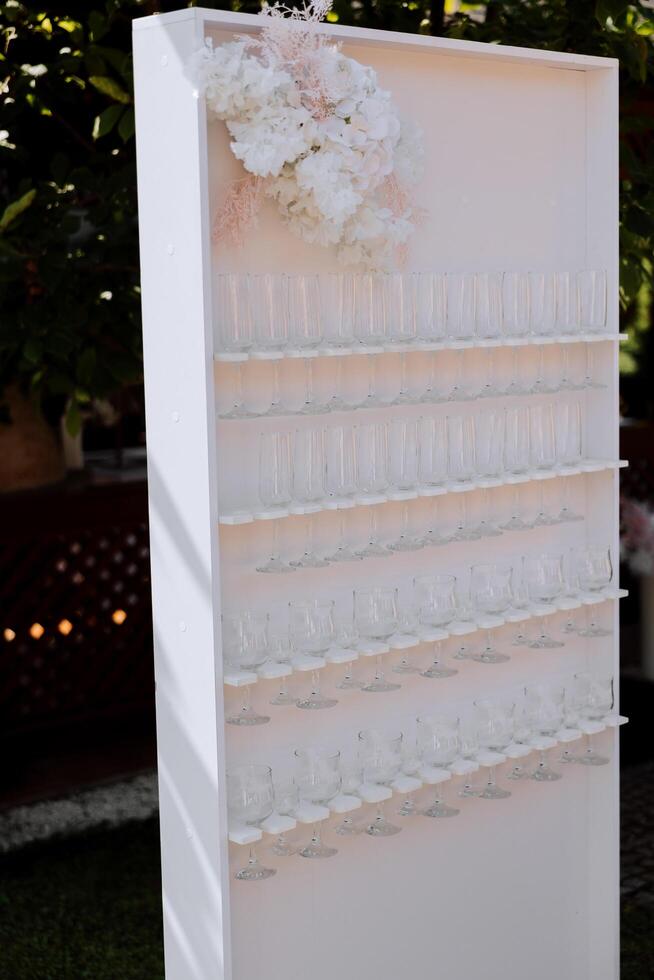 A stand for a champagne glass at a wedding. The beginning of the celebration. Wedding ceremony. Everything is ready for the celebration. photo