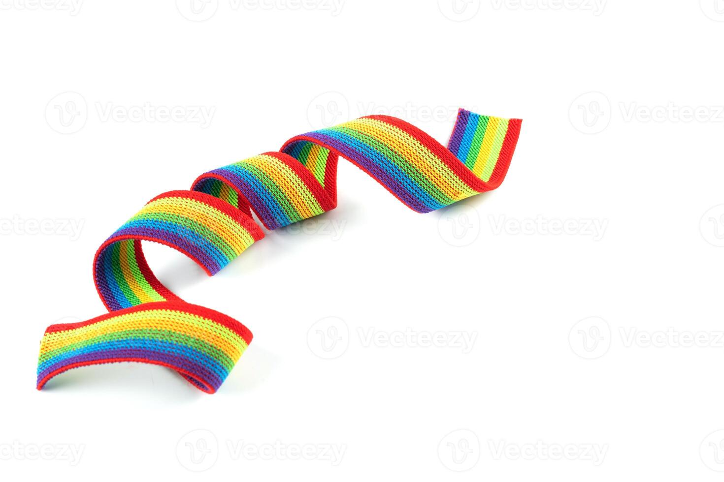 Colorful rainbow ribbon closeup isolated on white background. Colorful LGBT design. Curly, fluttering ribbon. photo