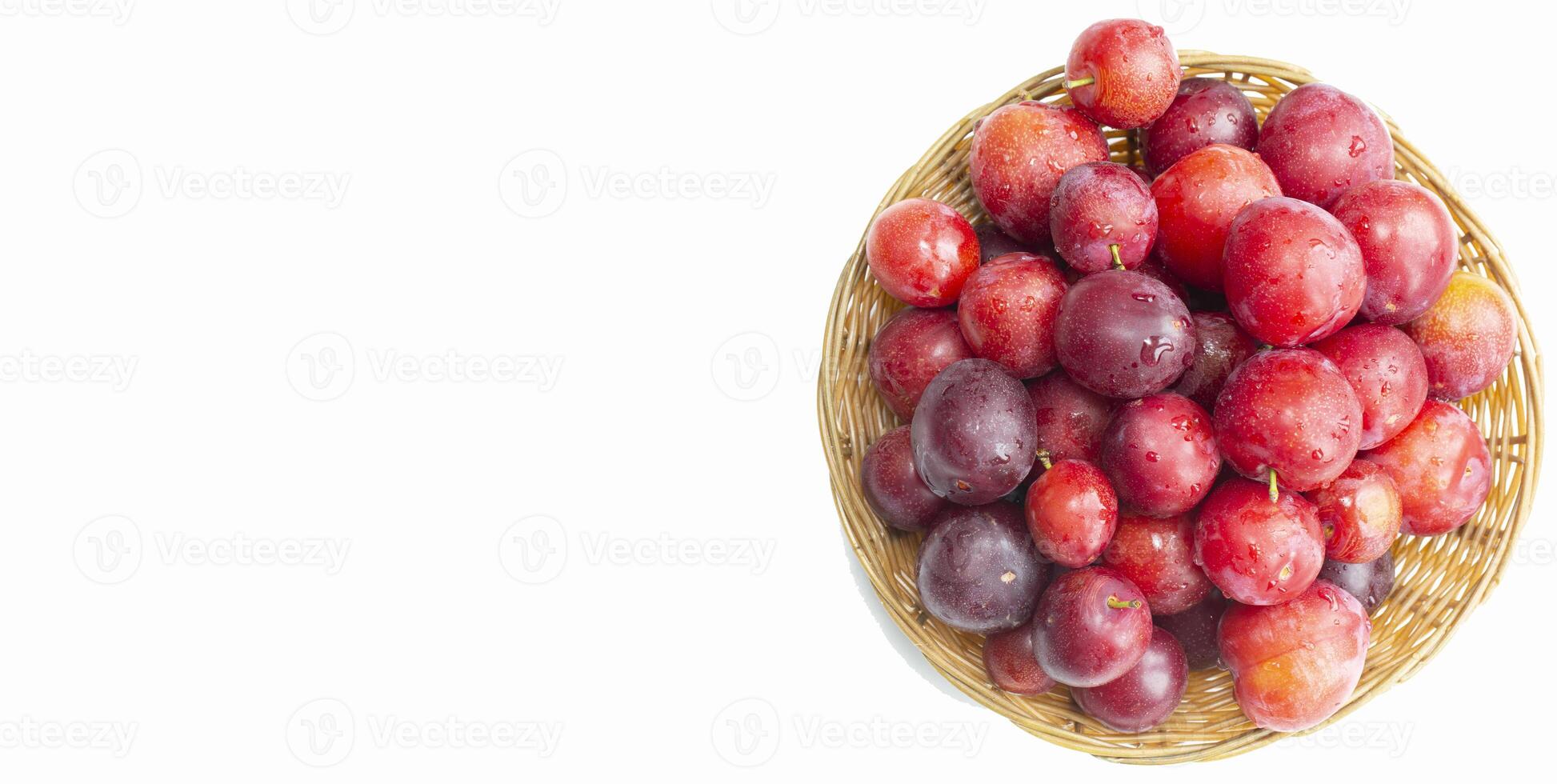 Plums in the basket top view on a white background photo