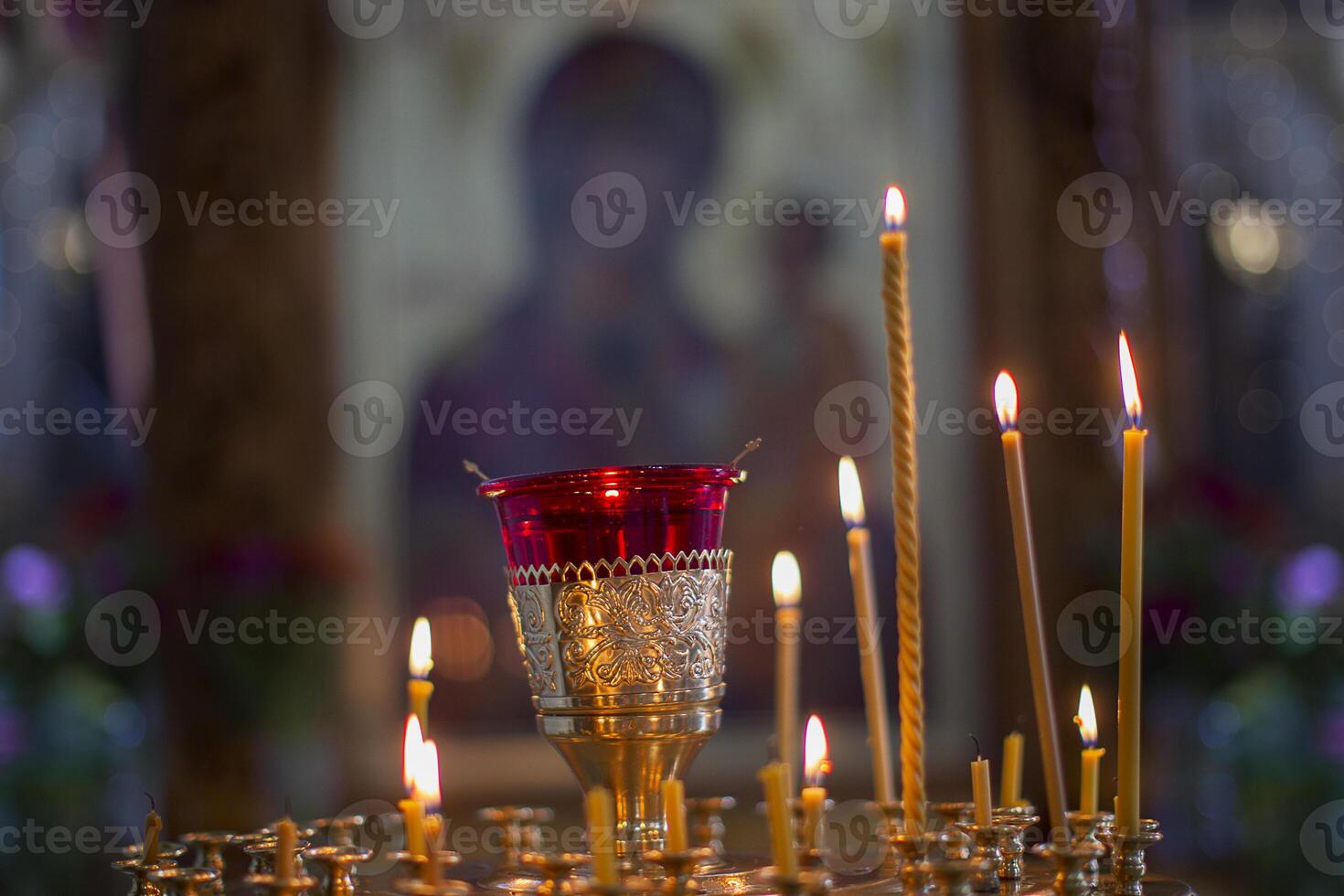 Church candles on the background of icons. Religion. photo