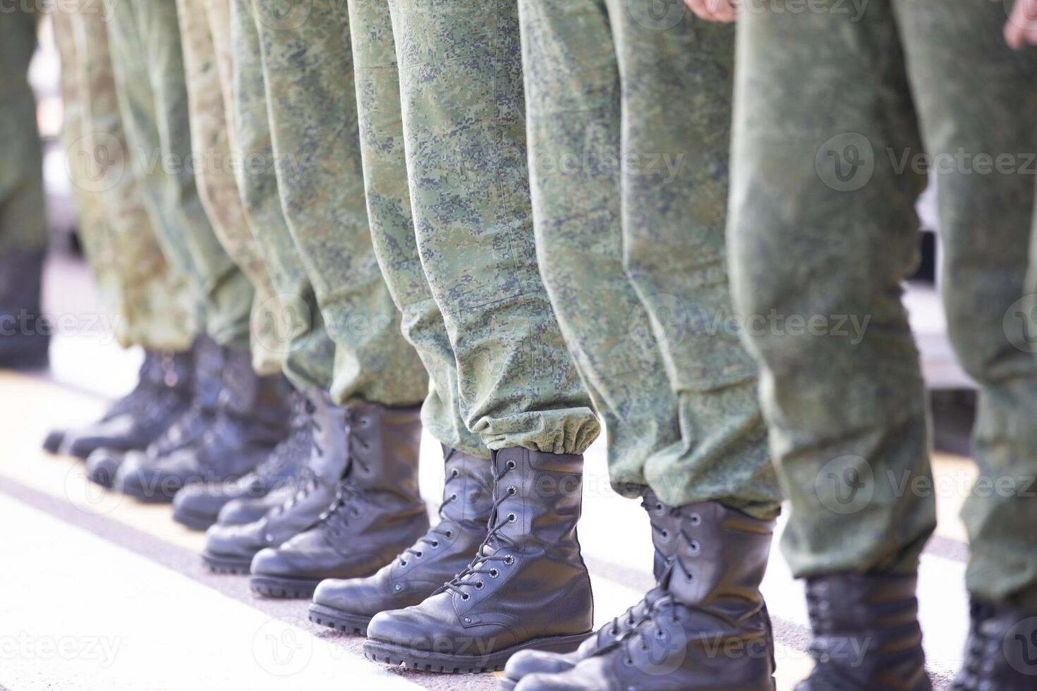 Line up soldiers in protective clothing and boots. They are sent to war or training. photo