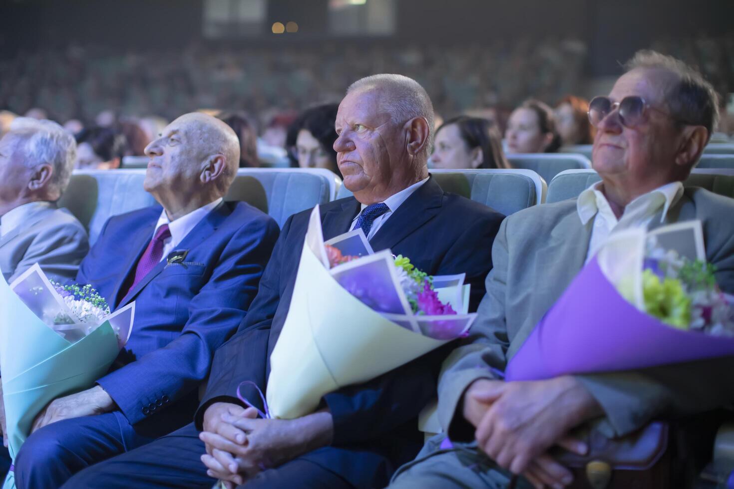 June 16, 2023. Belarus, Gomel. Public event. Spectators in the hall with flowers. photo