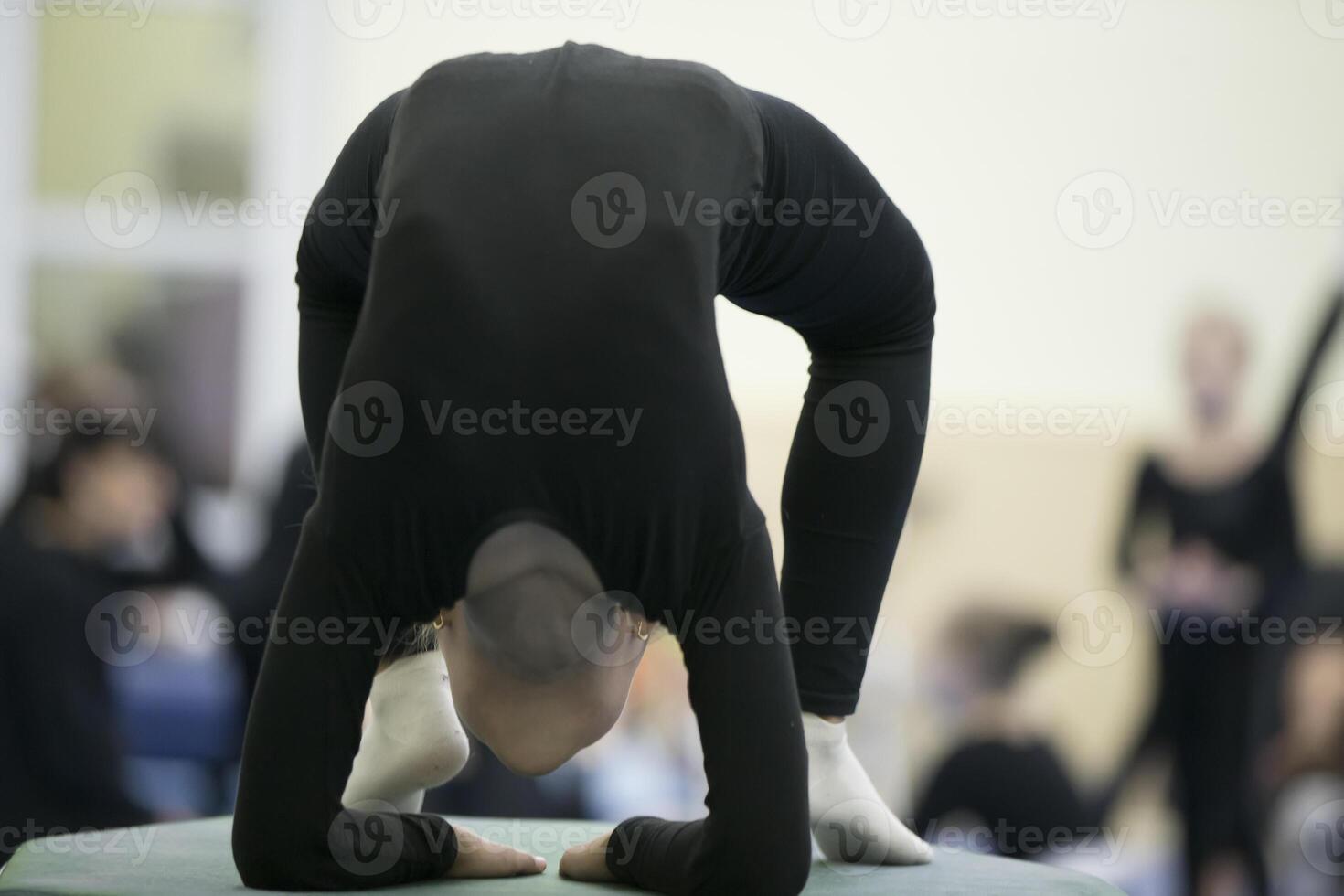 Gymnastic workout. Girl with a flexible body photo