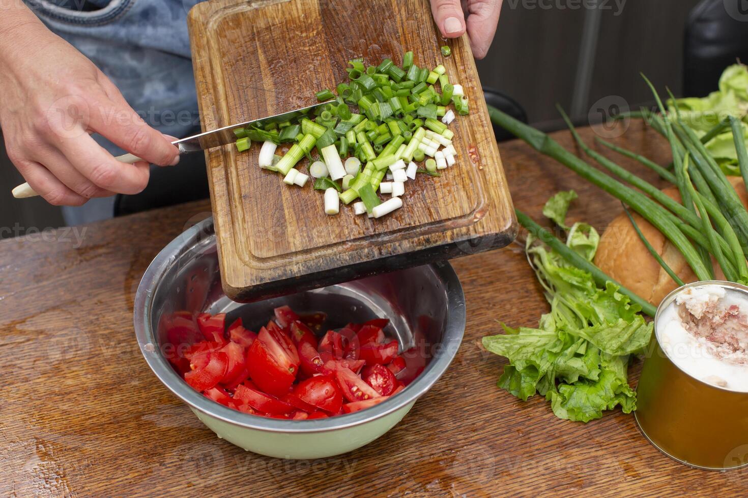 Chop the green onions and tomatoes and place them in a bowl. Prepare the salad. photo