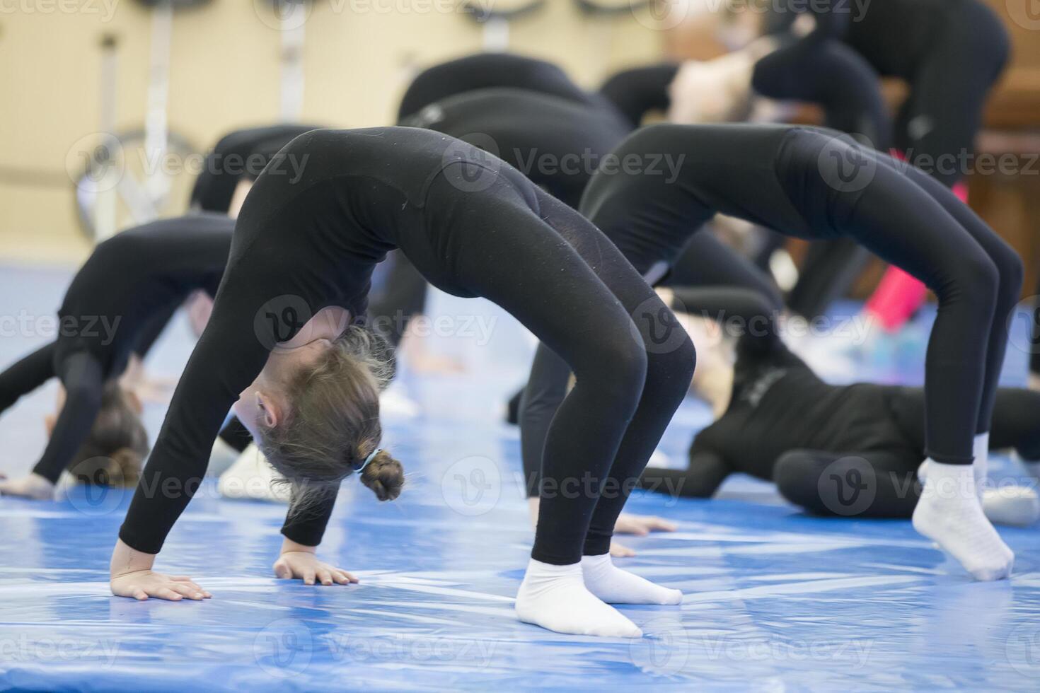 Children's gymnastics. Physical education class. Kids do sport exercises photo