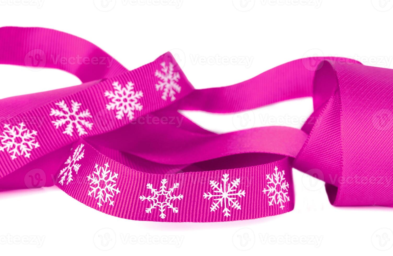 Christmas ribbon pink with white snowflakes with copy space. photo