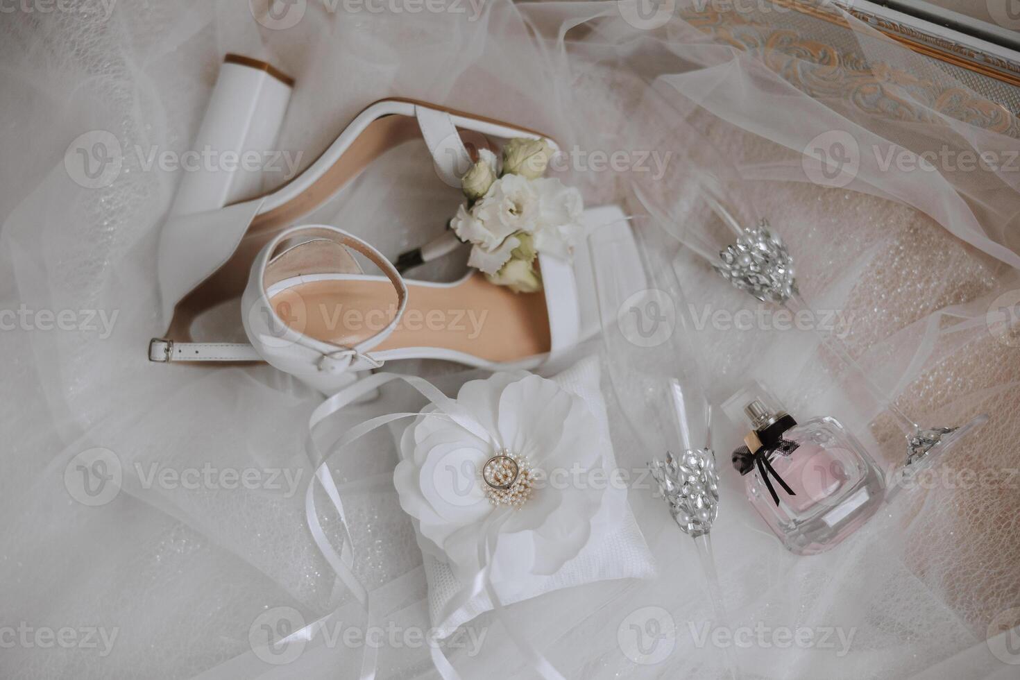 Bride's engagement ring, stilettos, Perfume. Wedding details of the bride. Flowers Beautiful light. wedding dress photo