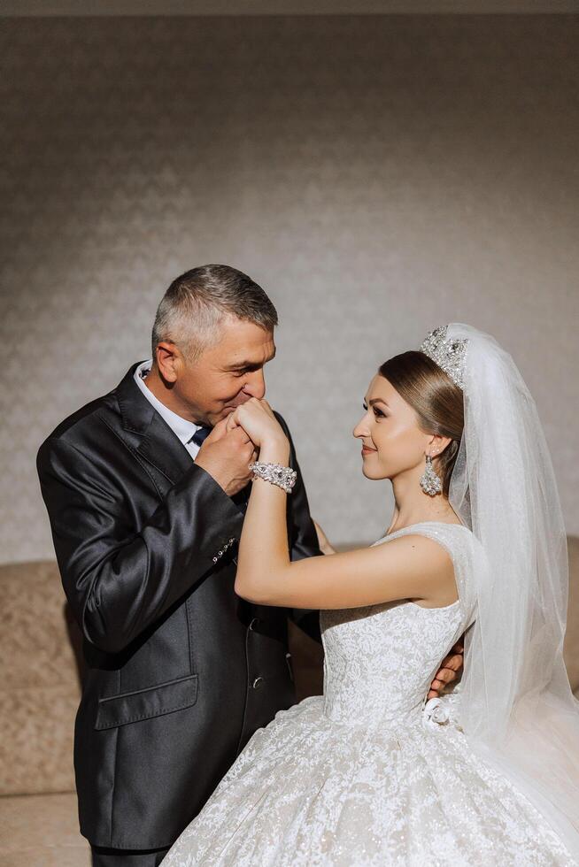 A beautiful bride with her father on her wedding day. The best moments of the wedding day. Daughter and father. photo