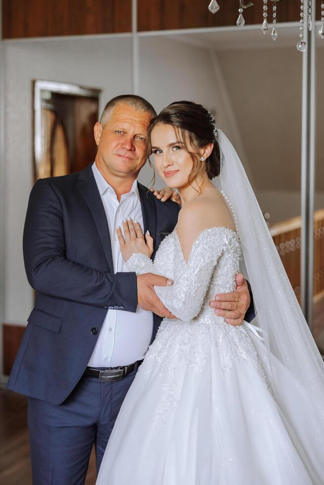 A beautiful bride with her father on her wedding day. The best moments of the wedding day. Daughter and father. photo