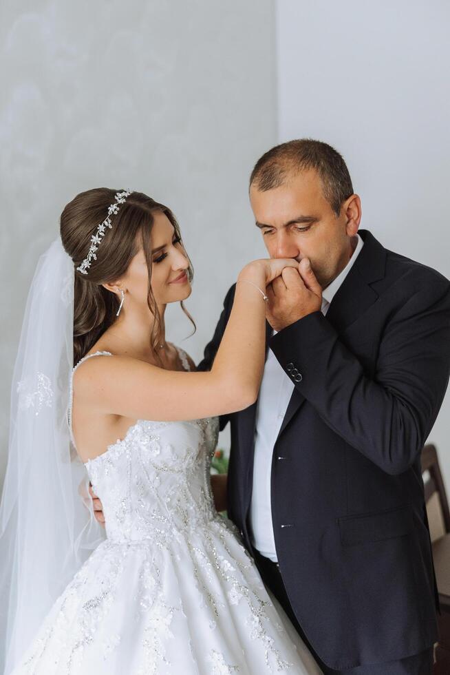 A beautiful bride with her father on her wedding day. The best moments of the wedding day. Daughter and father. photo