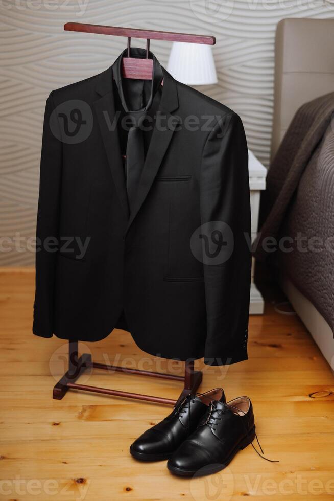 black men's suit. The man is ready to wear a business suit, white shirt and tie. A black jacket on a mannequin photo