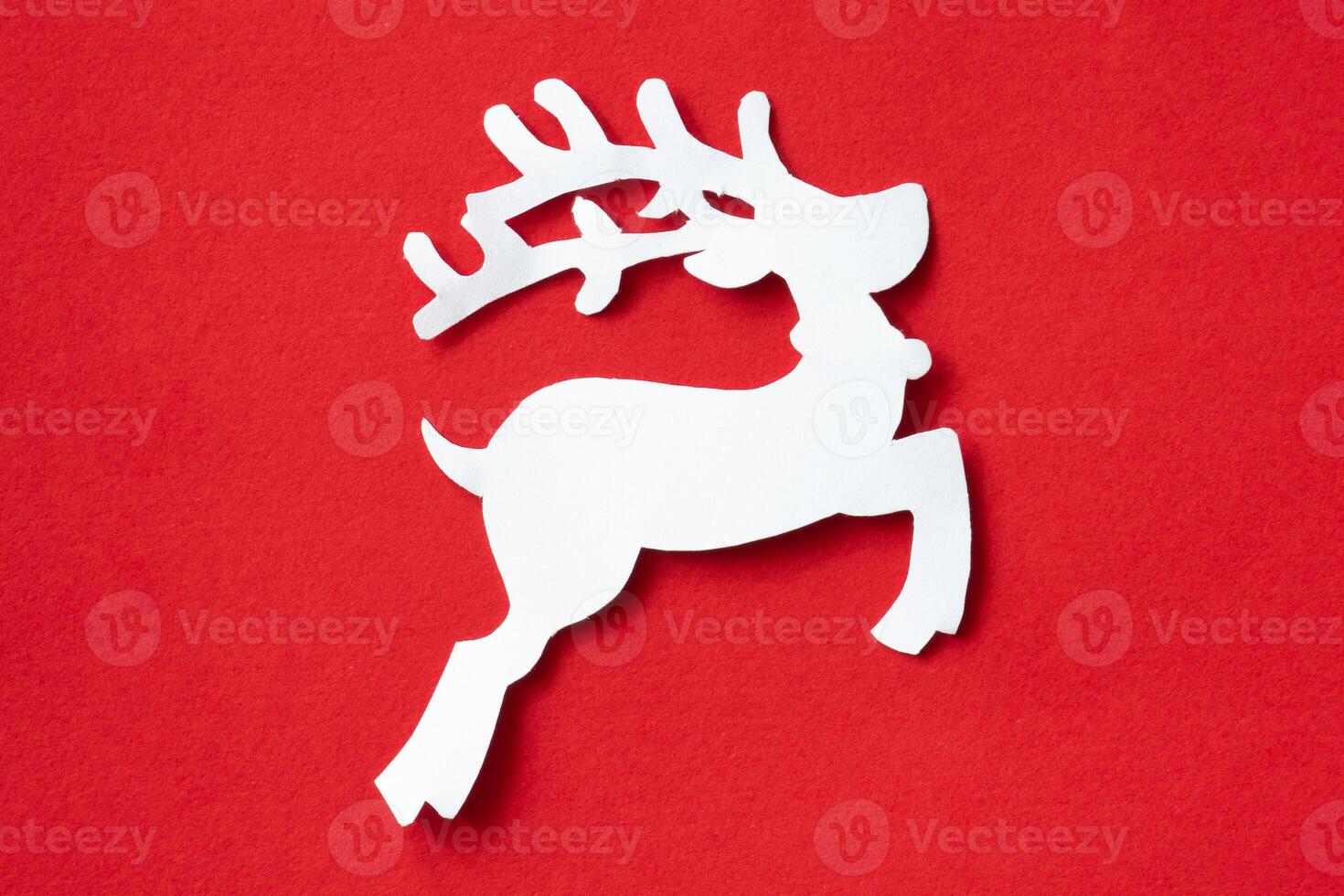 Christmas reindeer cut out paper on red background photo