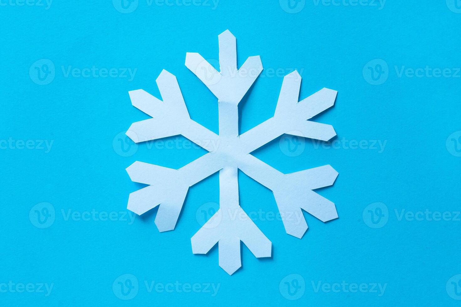 snowflake cut out paper on blue photo